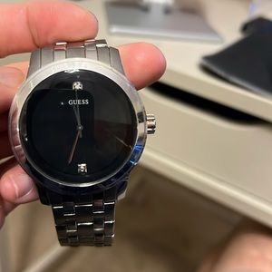 Guess battery operated watch. It has scratch on the face and steel belt.